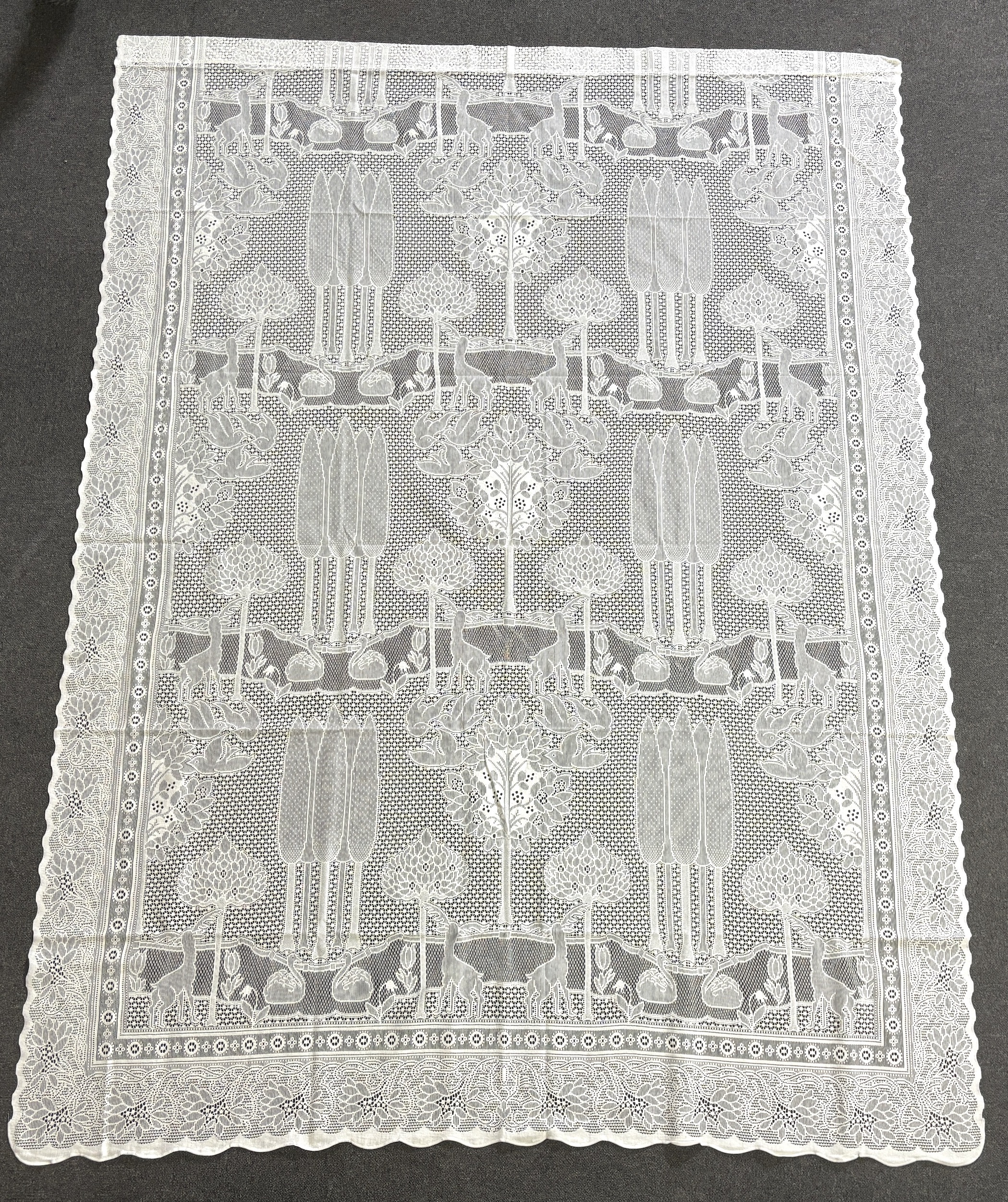 A set of three C.F.A. Voysey design “The Stag”, machine made, cotton lace curtains manufactured by Rose’s Mill Ltd, Ayrshire, unused, 180cm x 240cm